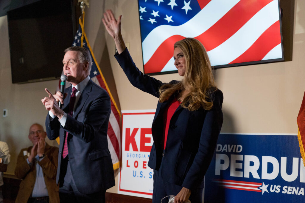 Sens. David Perdue and Kelly Loeffler speak at a campaign event this month at a restaurant in Cumming, Ga. Both are competing in runoff elections in January that will determine which party controls the Senate. Sens. David Perdue and Kelly Loeffler speak at a campaign event this month at a restaurant in Cumming, Ga. Both are competing in runoff elections in January that will determine which party controls the Senate. (Megan Varner/Getty Images)