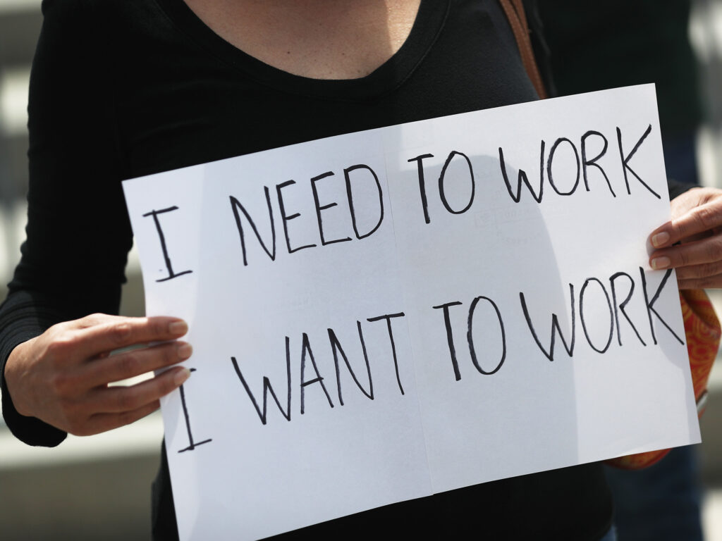 A protester holds a sign as she joins with restaurant owners, workers and supporters on July 10, 2020, to protest measures in Miami to close indoor seating amid a rise in coronavirus cases. The number of unemployment claims rose for a second week, reinforcing concerns about the economy. A protester holds a sign as she joins with restaurant owners, workers and supporters on July 10, 2020, to protest measures in Miami to close indoor seating amid a rise in coronavirus cases. The number of unemployment claims rose for a second week, reinforcing concerns about the economy. (Joe Raedle/Getty Images)