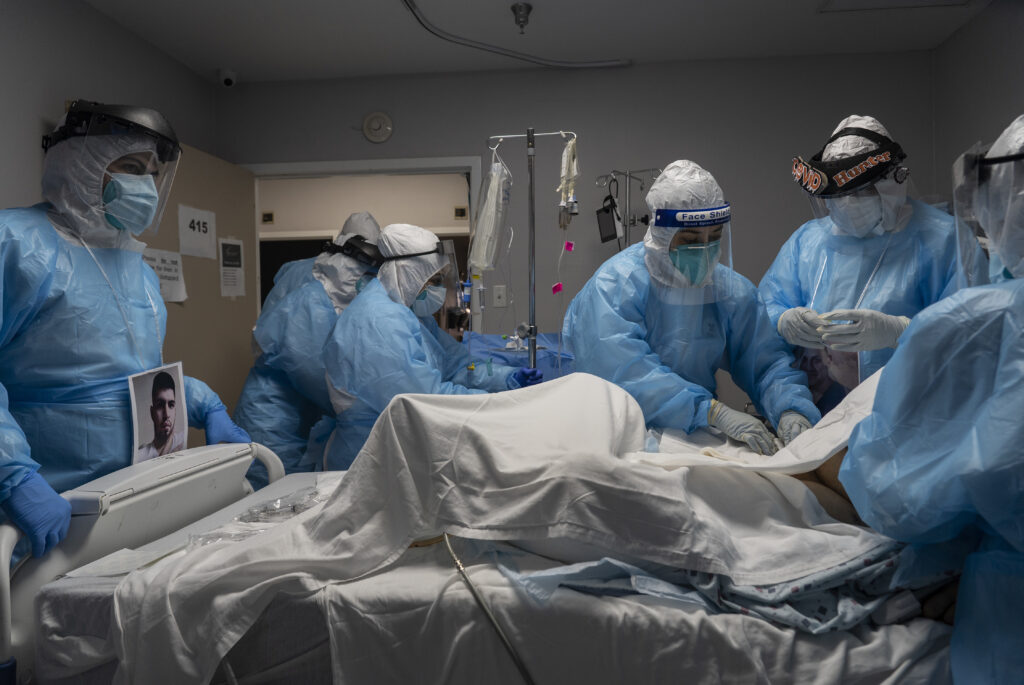Medical staff members treat a patient with COVID-19 last week in the intensive care unit of United Memorial Medical Center in Houston. Once a COVID-19 vaccine is available, experts say immunizing health workers first is the best way to curb deaths and stop transmission.