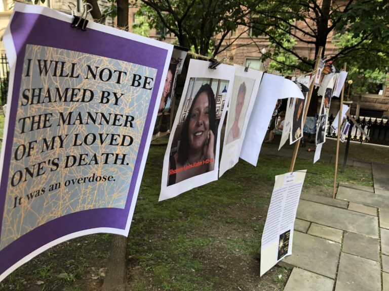 Photographs and words of recovery hang near Trinity Cathedral in downtown Pittsburgh as part of a remembrance of victims during Overdose Awareness Day