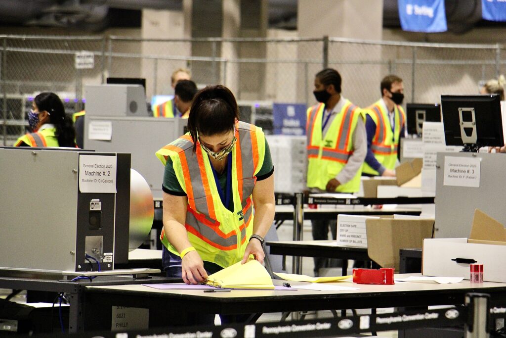 philly_mail_ballots_election_2020_EL_110420_03 Election workers scan ballots at the Pennsylvania Convention Center. Officials anticipate that the task of scanning mail and absentee ballots will be completed Thursday.