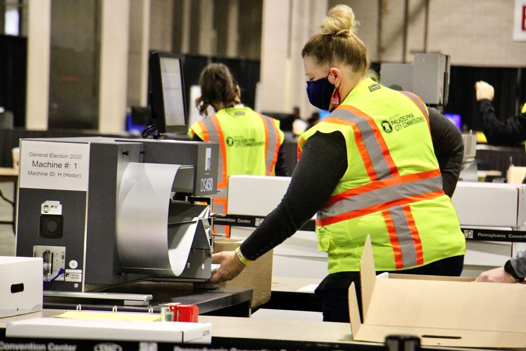 philly_mail_ballots_election_2020_EL_110420_05 Election workers scan ballots at the Pennsylvania Convention Center. Officials anticipate that the task of scanning mail and absentee ballots will be completed Thursday.