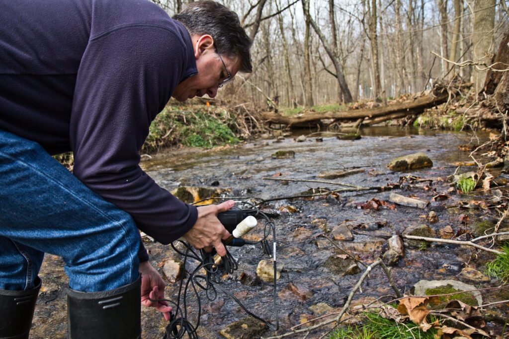 stroud-8-1920×1280 John Jackson, senior research scientist at the Stroud Water Research Center, measure conductivity in the White Clay Creek stream. (Kimberly Paynter/WHYY)