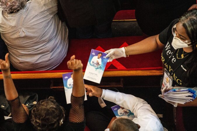 The New Temple Baptist Church staff hand out programs at Walter Wallace Jr.’s funeral service.