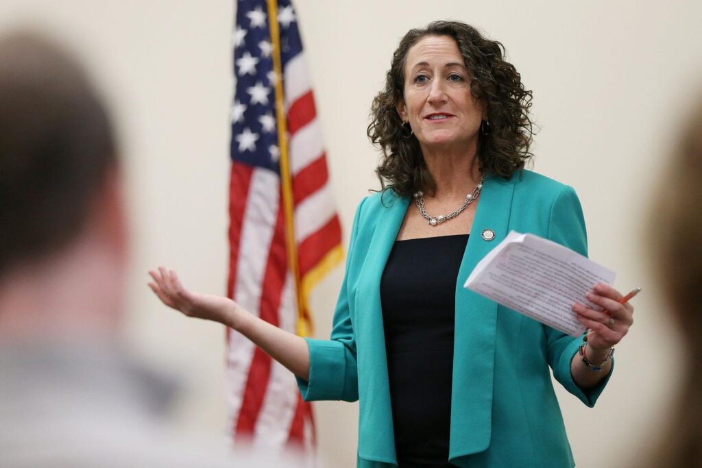 Kathy Boockvar gestures while holding a piece of paper