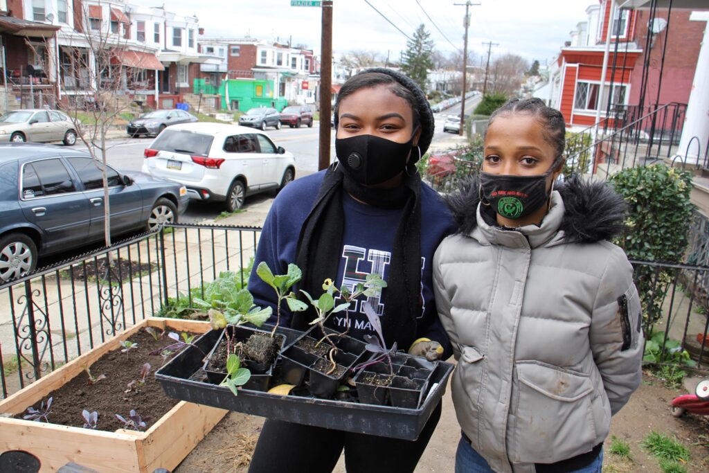 2020 12 01-e lee-princess rahman hajjah glover-southwest philadelphia-sankofa raised garden bed Princess Rahman (left) and Hajjah Glover finish installing a raised garden bed in Southwest Philadelphia. (Emma Lee/WHYY)