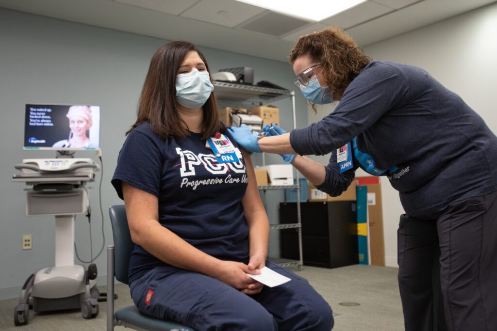 20201215-bayhealth-covid-vaccine-Elisabeth-Cote-scaled Bayhealth nurse Elisabeth Cote was vaccinated by co-worker Brittany Oakley