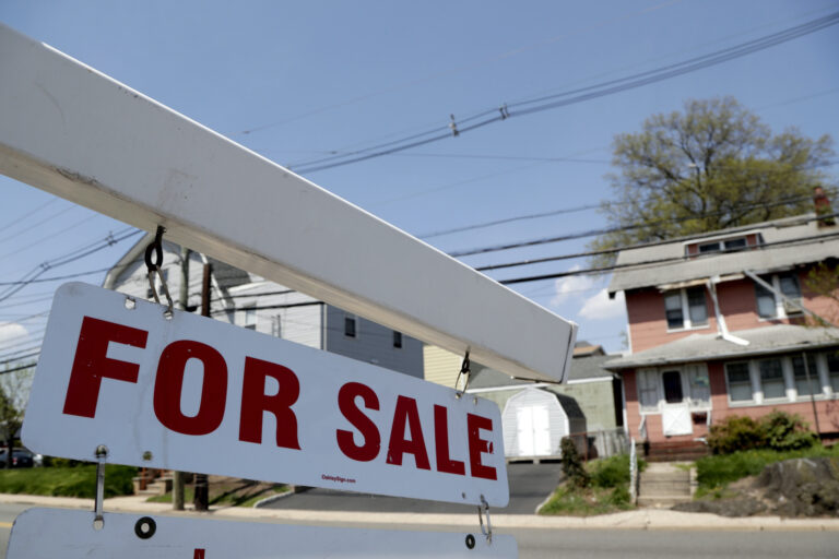 A for sale sign hangs from a post outside of a vacant business building, Thursday, May 3, 2018, in Belleville, N.J. (AP Photo/Julio Cortez)