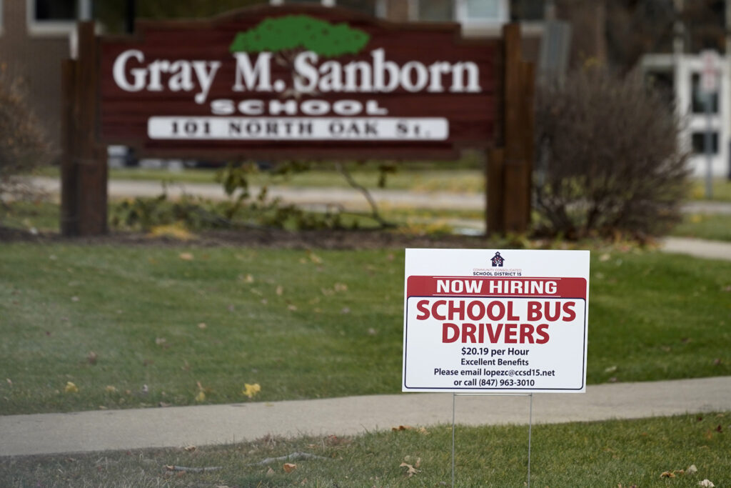 Virus Outbreak-Unemployment Benefits A hiring sign shows outside of Gray M. Sanborn Elementary School in Palatine, Ill., Thursday, Nov. 5, 2020. Illinois reports biggest spike in unemployment claims of all states. On Wednesday, Dec. 23, the number of Americans seeking unemployment benefits fell by 89,000 last week to a still-elevated 803,000, evidence that the job market remains under stress nine months after the coronavirus outbreak sent the U.S. economy into recession and caused millions of layoffs. (AP Photo/Nam Y. Huh)