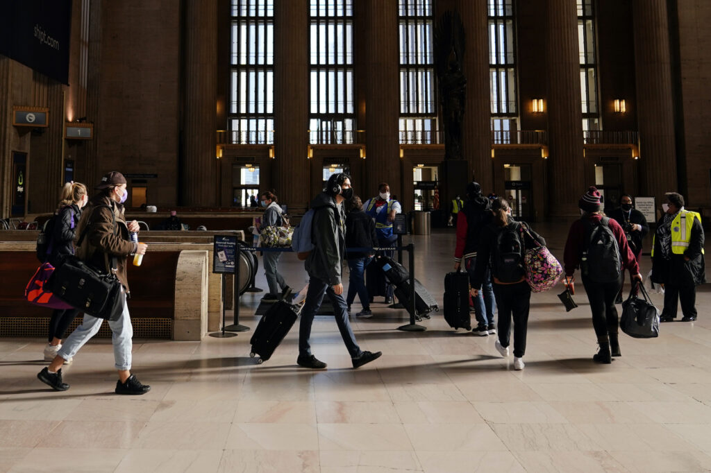 Virus Outbreak Holiday Travel Travelers wait in line to board a train at the 30th Street Station ahead of the Thanksgiving holiday, Friday, Nov. 20, 2020, in Philadelphia. (AP Photo/Matt Slocum)