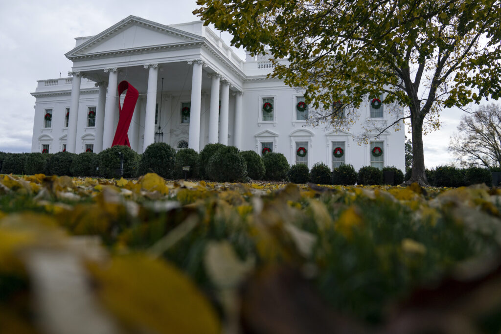 Donald Trump A ribbon hangs on the White House for World AIDS Day 2020, Tuesday, Dec. 1, 2020, in Washington. (AP Photo/Evan Vucci)