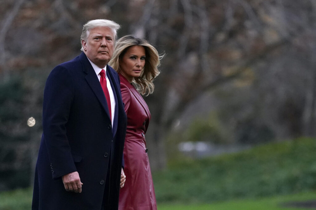 President Donald Trump and first lady Melania Trump walk on the South Lawn of the White House in Washington, Saturday, Dec. 5, 2020, before boarding Marine One for a short trip to Andrews Air Force Base, Md. (AP Photo/Patrick Semansky)