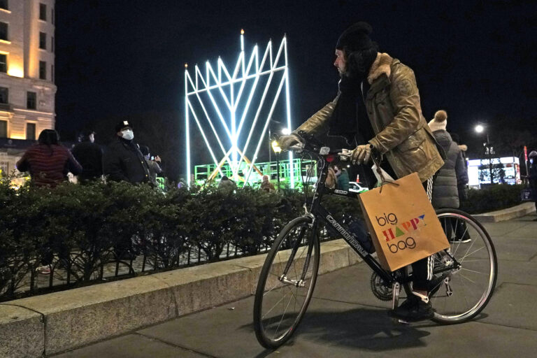 A man on a bicycle pauses on the sidewalk along Fifth Avenue in Manhattan near what has been described as 