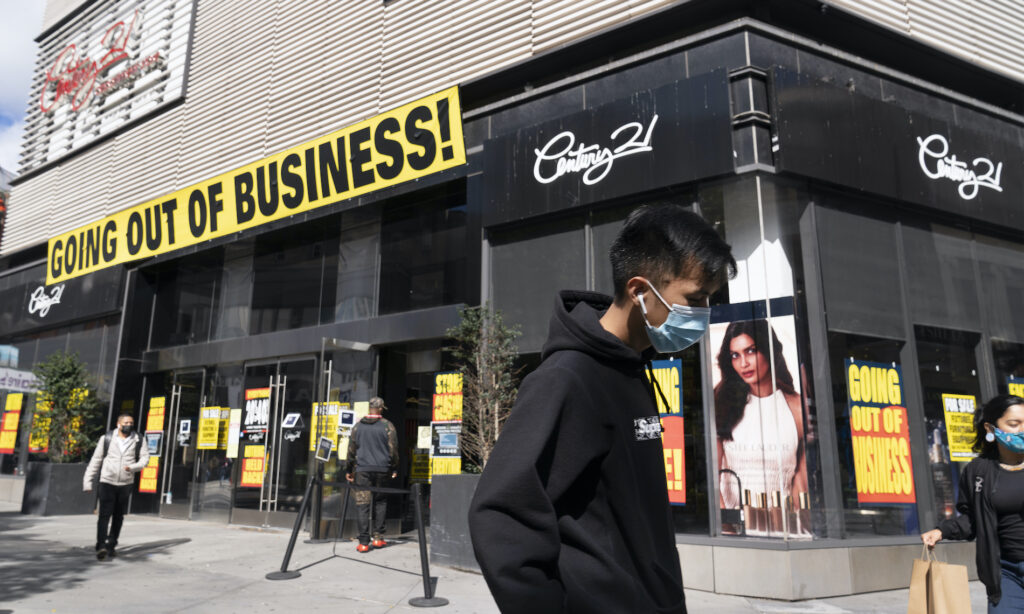 New Laws In this Wednesday, Sept. 30, 2020, file photo, a man wearing a mask amid the coronavirus pandemic walks by a Century 21 department store, in the Brooklyn borough of New York. (AP Photo/Mark Lennihan)
