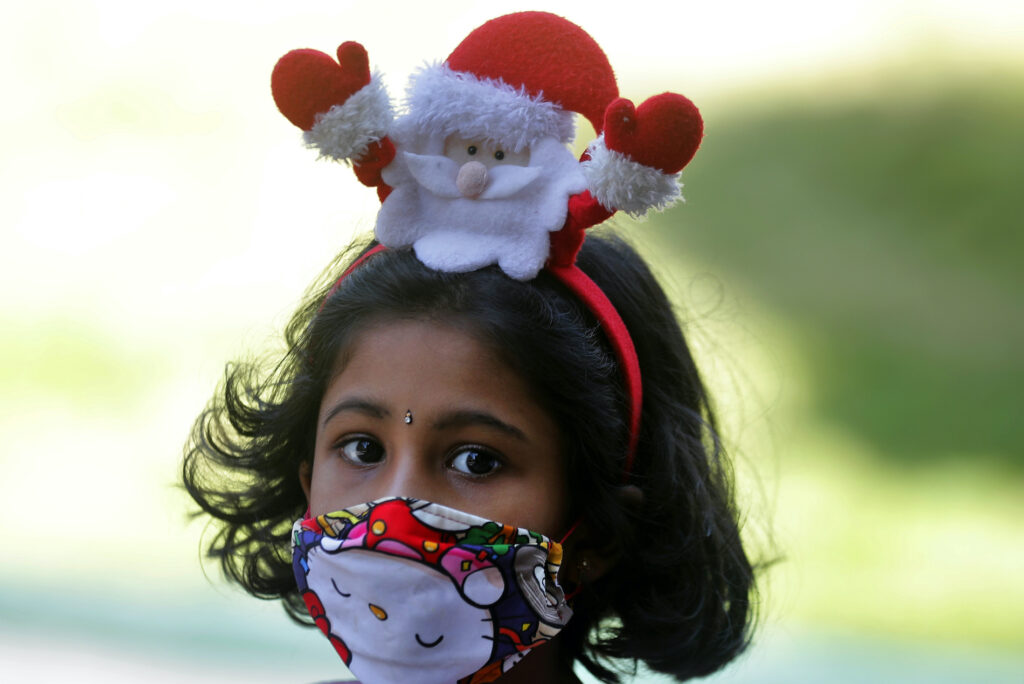 Virus Outbreak Sri Lanka Christmas A Sri Lankan Catholic girl wears a hair band with a Santa figure arrives at a church to attend the Christmas Day holly mass in Colombo, Sri Lanka, Friday, Dec. 25, 2020. (AP Photo/Eranga Jayawardena)