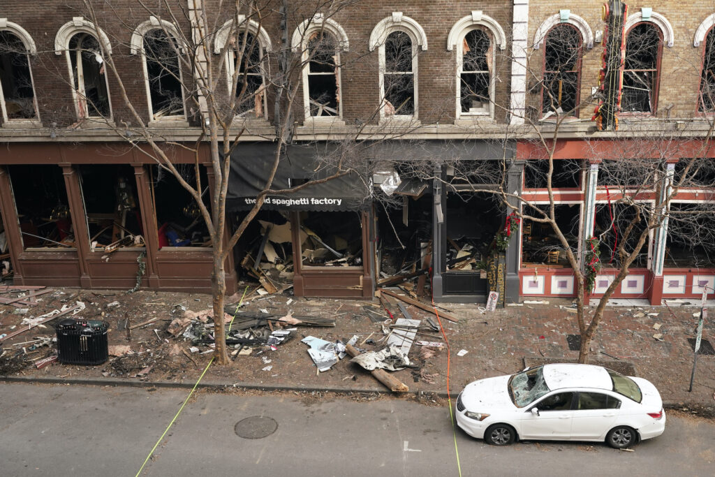 Explosion Nashville Telecom Vulnerability In this Dec. 29, 2020 file photo, debris remains on the sidewalk in front of buildings damaged in a Christmas Day explosion in Nashville, Tenn. (AP Photo/Mark Humphrey)