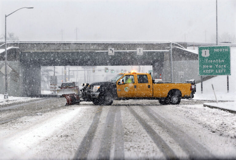 A snow plow drives across a road in a heavy snowfall in Morrisville, Pa. (AP Photo/Mel Evans)
