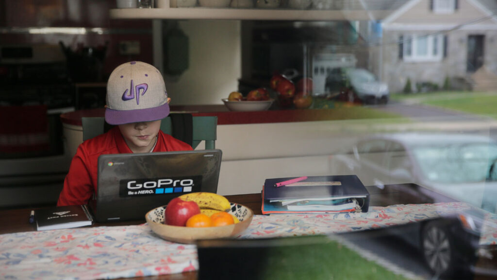 AP_Online-remote-learning-virtual-teaching-COVID A young student attends virtual school from his home