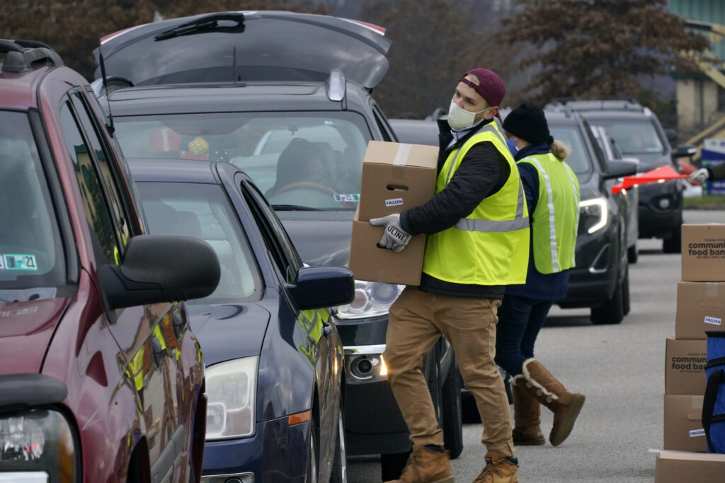 Virus Outbreak Pennsylvania Volunteers load boxes of food into a car during a Greater Pittsburgh Community Food bank drive-up food distribution