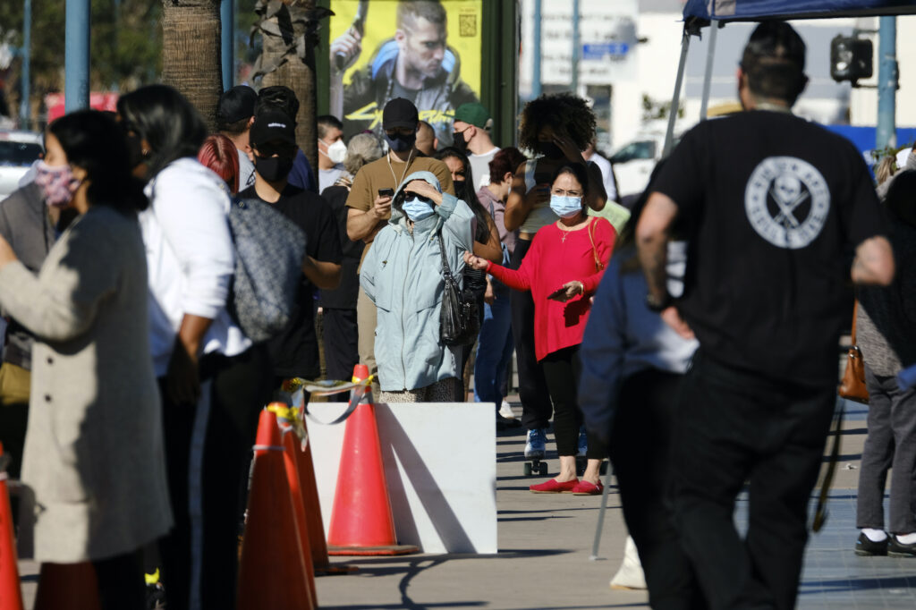 Virus Outbreak California People wait in line to be tested for COVID-19 at a testing site in the North Hollywood section of Los Angeles