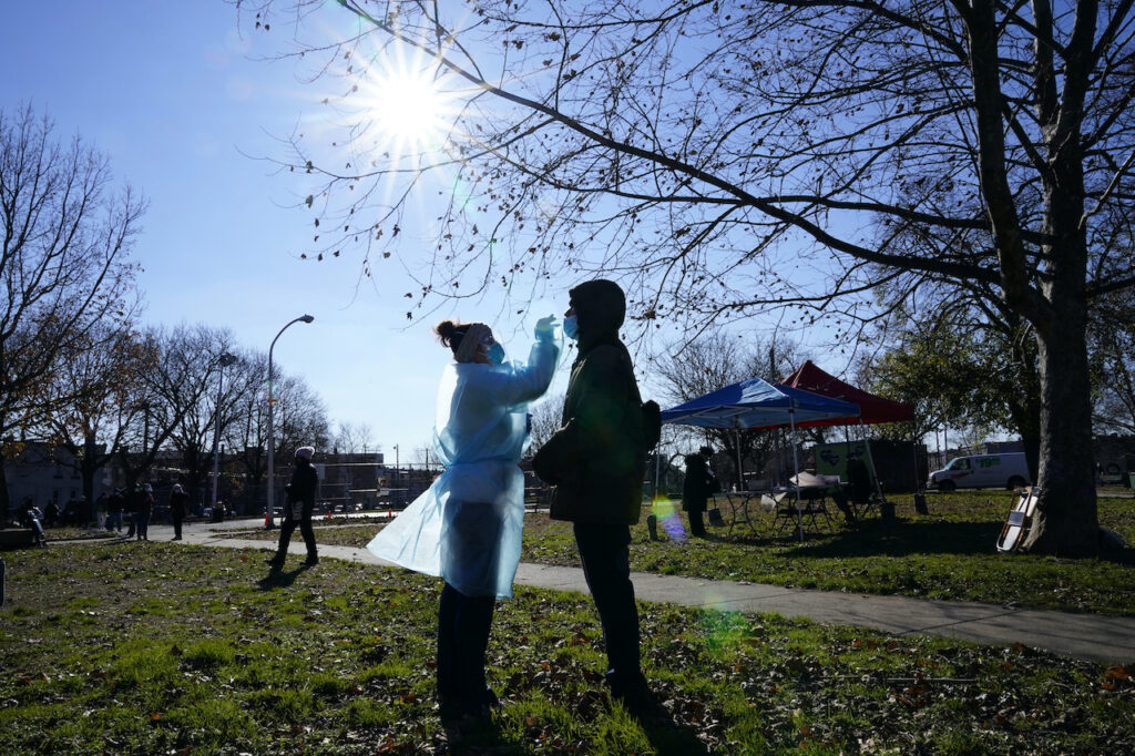 Virus Outbreak Pennsylvania Registered nurse Laura Moore, left, swabs Andry Laurens during testing for COVID-19 in Mifflin Square Park