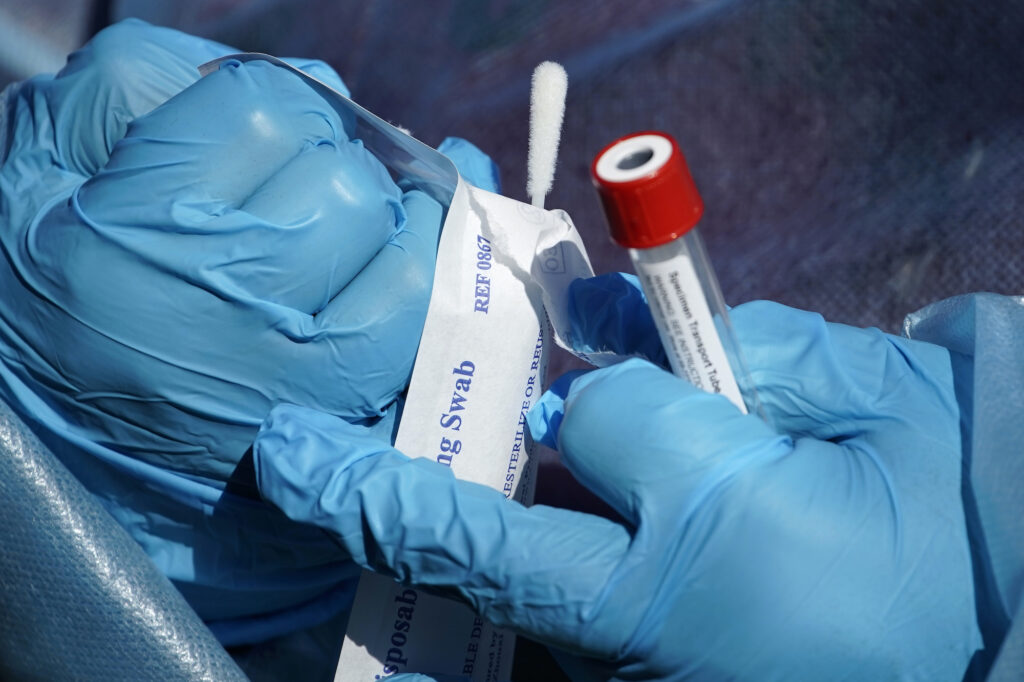 Virus Outbreak Pennsylvania Registered nurse Tria Jones opens a swab during testing for COVID-19