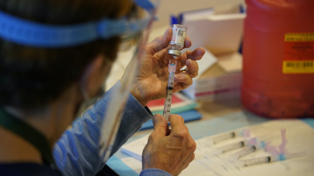 Virus Outbreak Vaccine Pennsylvania Pat Moore, with the Chester County, Pa., Health Department, fills a syringe with Moderna COVID-19 vaccine