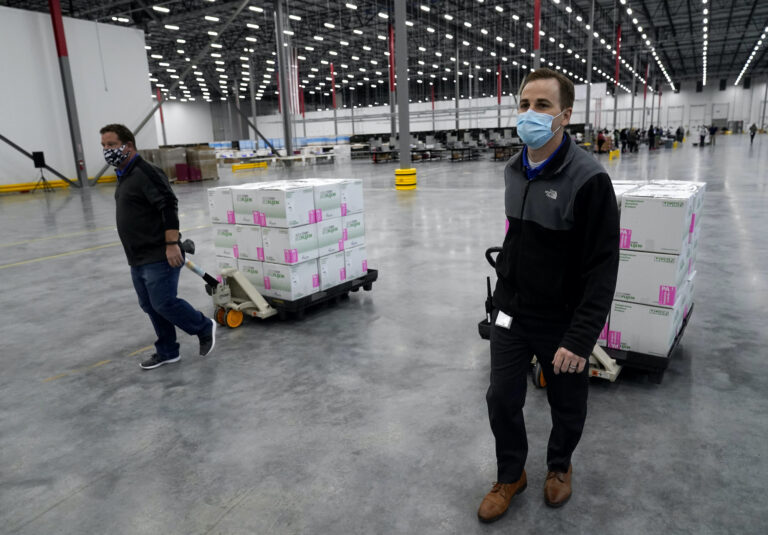 Boxes containing the Moderna COVID-19 vaccine are prepared to be shipped at the McKesson distribution center