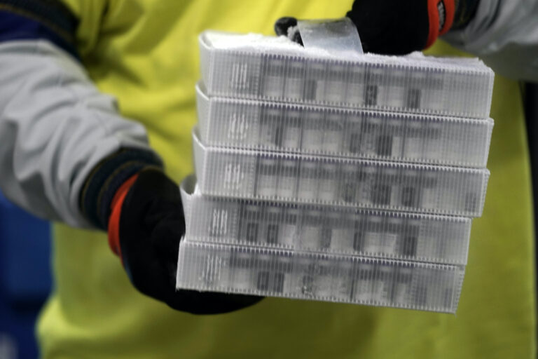 Boxes containing the Pfizer-BioNTech COVID-19 vaccine are prepared to be shipped at the Pfizer Global Supply Kalamazoo manufacturing plant