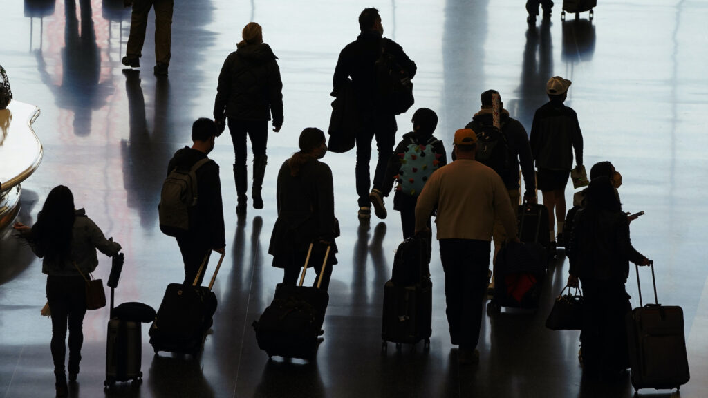 Virus Outbreak Holiday Travel Travelers walk through the Salt Lake City International Airport