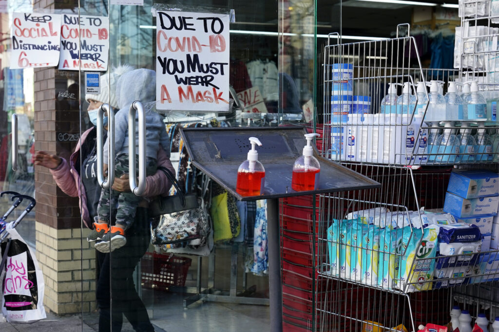 Virus Outbreak New Jersey A sign warns patrons to wear a mask in the Ironbound section of Newark