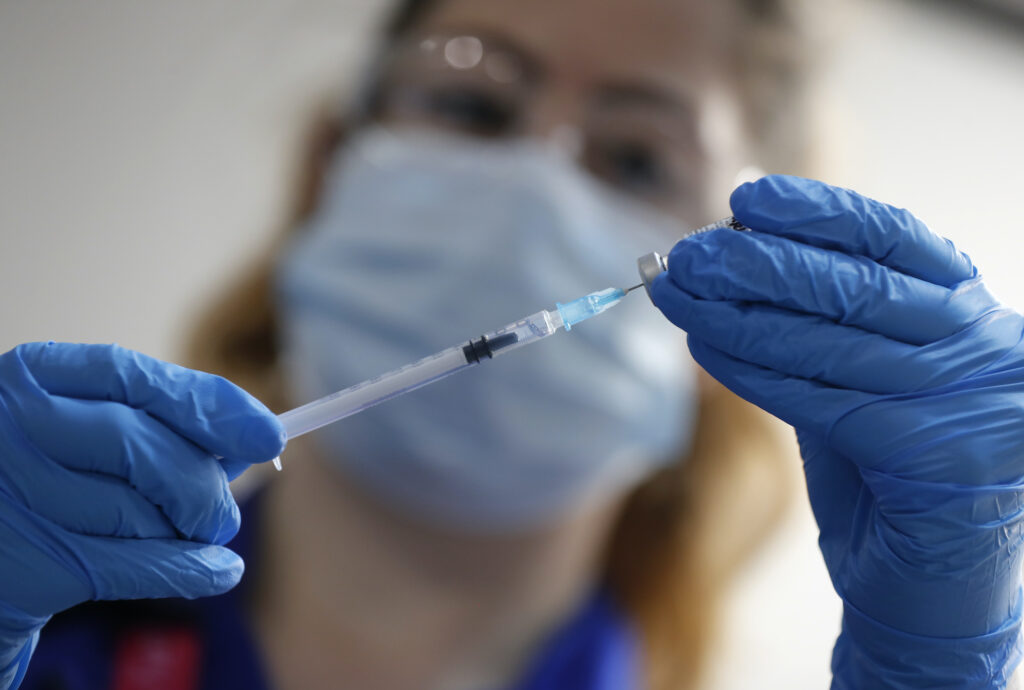 Virus Outbreak Britain Vaccine A nurse prepares to administer the Pfizer-BioNTech COVID-19 vaccine at Guy’s Hospital in London