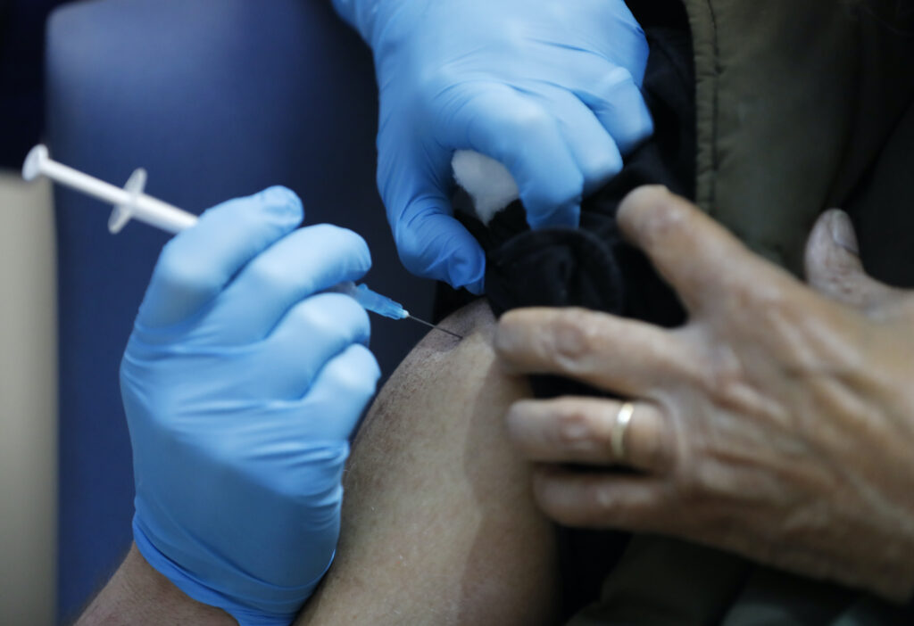 APTOPIX Virus Outbreak Britain A nurse administers the Pfizer-BioNTech COVID-19 vaccine at Guy’s Hospital in London