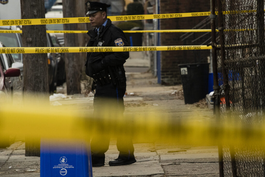 Philadelphia Homicides A Philadelphia police officer stands by a crime scene on Woodstock Street