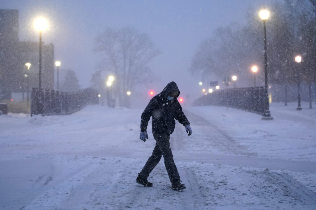 Virus Outbreak Winter is Coming A man walks through Villanova University campus during a snow storm