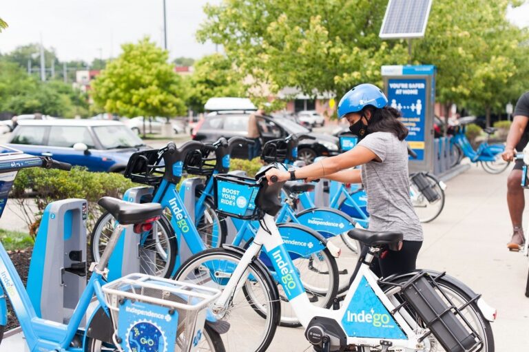 An Indego user docks an electric bike.