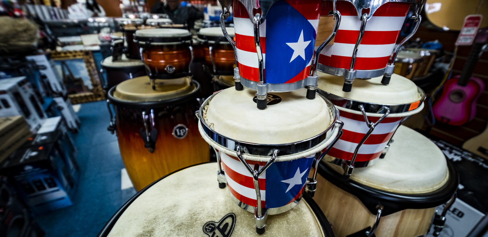 Bongos and congas adorned with the Puerto Rican flag. | Bongos y congas adornados con la bandera puertorriqueña. (Photo by Bernardo Morillo for WHYY)