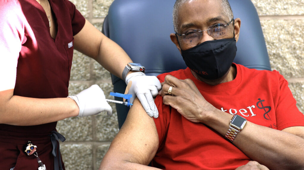 Robert Johnson, dean of Rutgers New Jersey Medical School, receives his first COVID-19 shot.