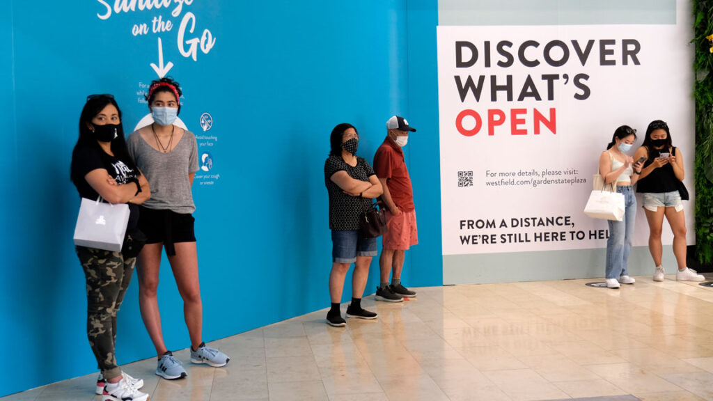 Garden-State-Plaza-Mall-Paramus-shoppers-COVID-19-coronavirus In this June 29, 2020, customers waited in line to enter a store at Garden State Plaza in Paramus, New Jersey. (Seth Wenig/AP Photo)