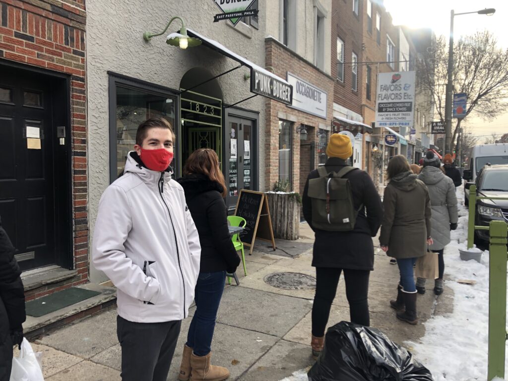 IMG_7305 Nick Lukow waits in line to enter Ocassionate gift shop in South Philly. (Miles Bryan/WHYY)