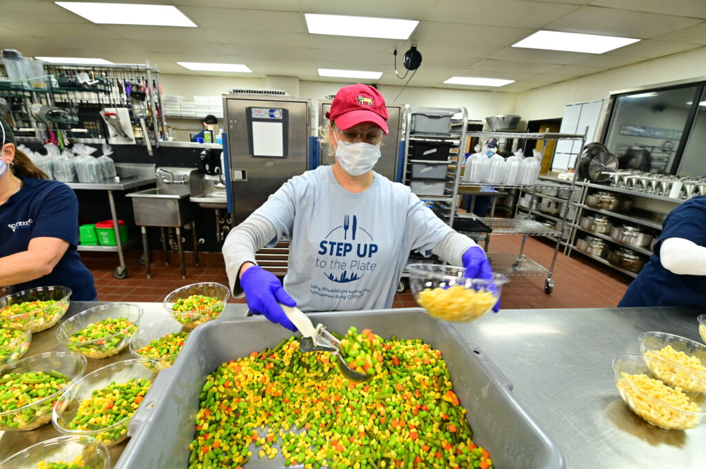 StepUp Catering by Design_JeffHolder (36) A volunteer prepares a meal via Catering by Design