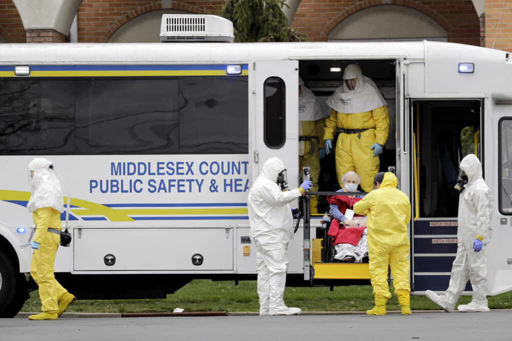 For the 78 residents of St. Joe’s, the arrival of hazmat-suited officials in their caravan of ambulance buses was terrifying. Some evacuees with dementia shouted and furiously clawed at them. Others begged not to be taken away. Residents from St. Joseph's Senior Home are helped onto buses in Woodbridge, N.J.,