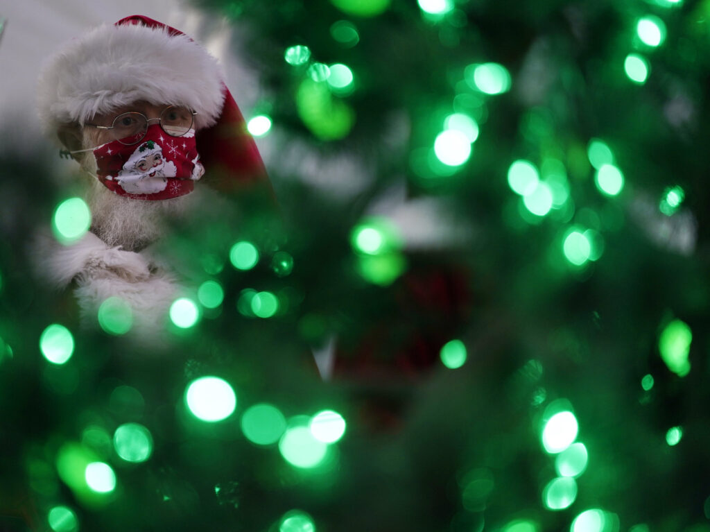 Virus Outbreak Safe Santas Photo Gallery Bill Sandeen, dressed as Santa Claus, waits for the opening of a Santa drive-through selfie station in Las Vegas