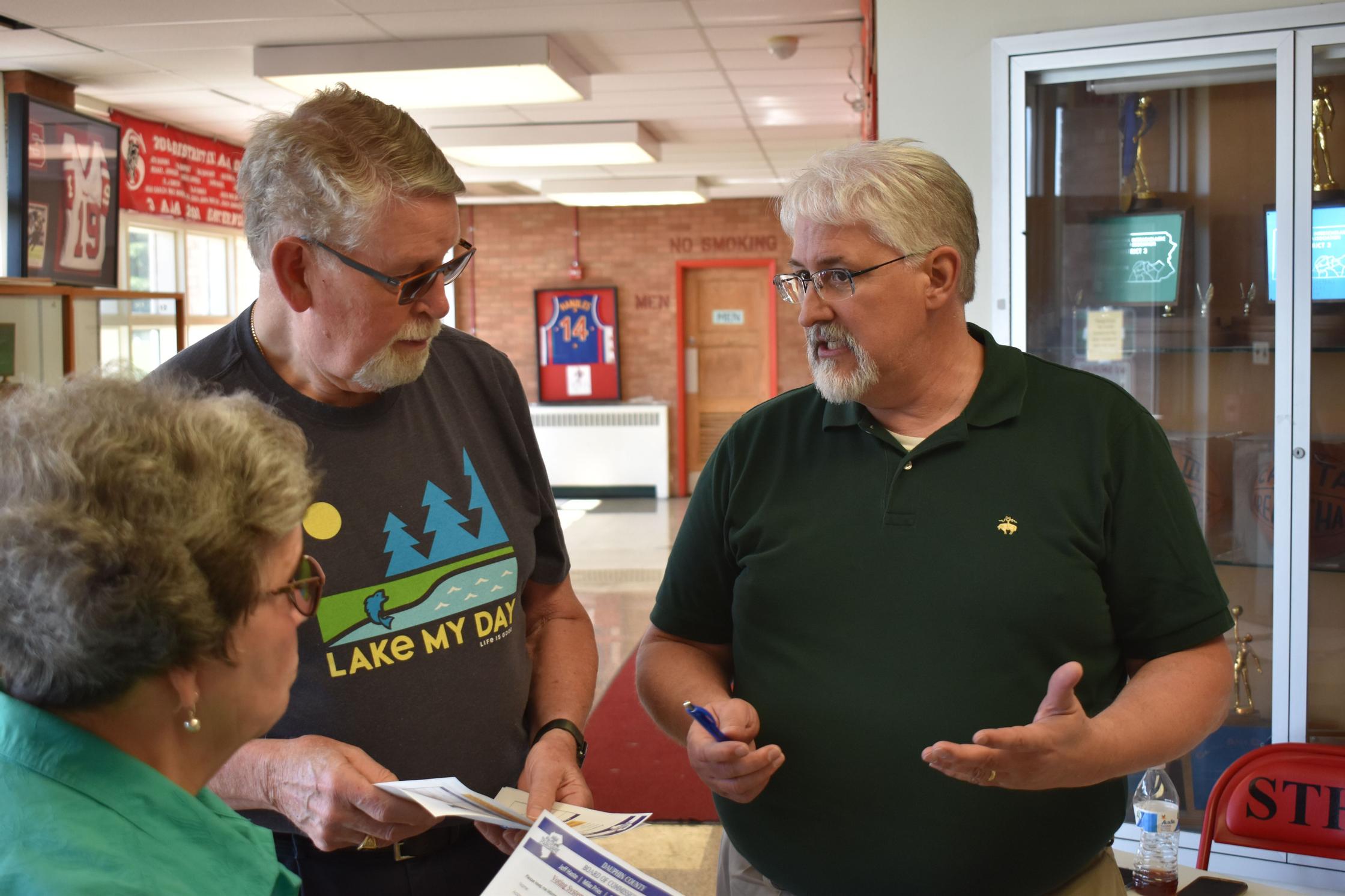 Election workers gather in a circle in Dauphin County