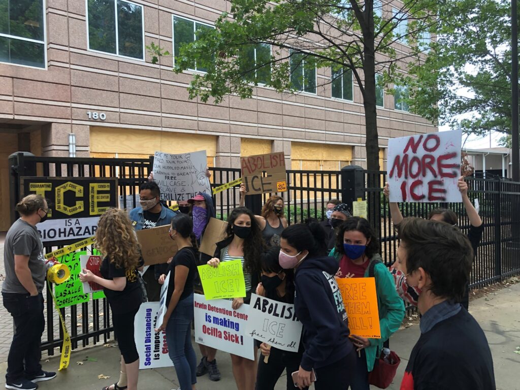 Protesters at a news conference outside ICE's Atlanta field office in September after the release of a whistleblower report about conditions at Irwin County Detention Center in Ocilla, Ga. (Jeff Amy/AP)