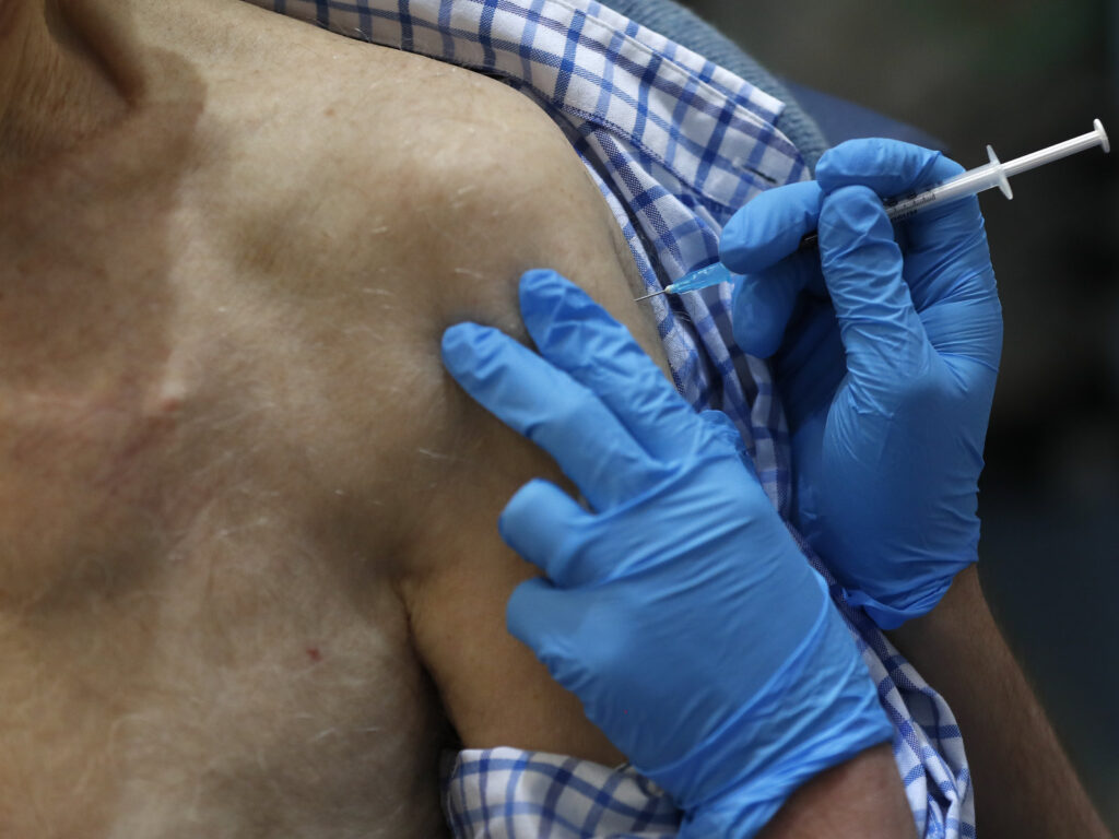 A nurse administers the Pfizer-BioNTech COVID-19 vaccine at Guy's Hospital