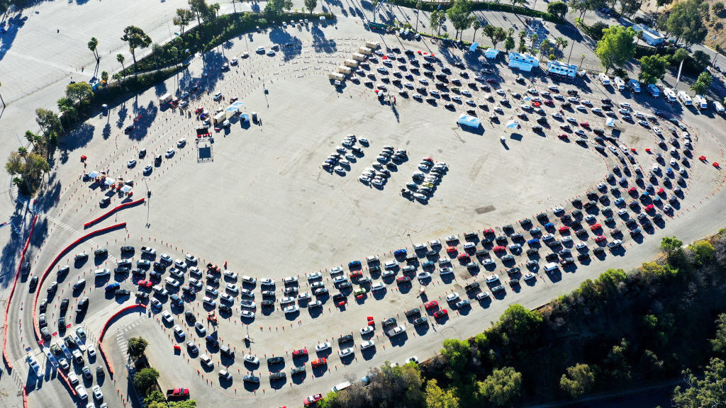 Cars are lined up at Dodger Stadium in Los Angeles for coronavirus testing on November 30, 2020. Nearly 2 million people are currently getting tested a day in the U.S. Cars are lined up at Dodger Stadium in Los Angeles for coronavirus testing