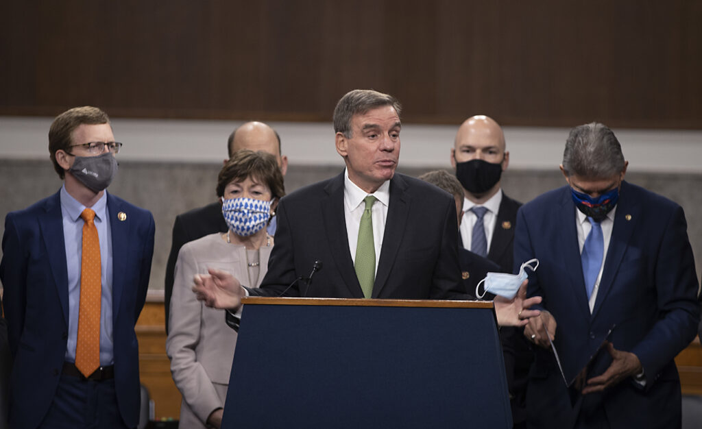 Sen. Mark Warner (D-VA) speaks alongside a bipartisan group of Democrat and Republican members of Congress as they announce a proposal for a $908 billion Covid-19 relief bill on Capitol Hill on Dec. 01, 2020 Sen. Mark Warner (D-VA) speaks alongside a bipartisan group of Democrat and Republican members of Congress as they announce a proposal for a $908 billion Covid-19 relief bill