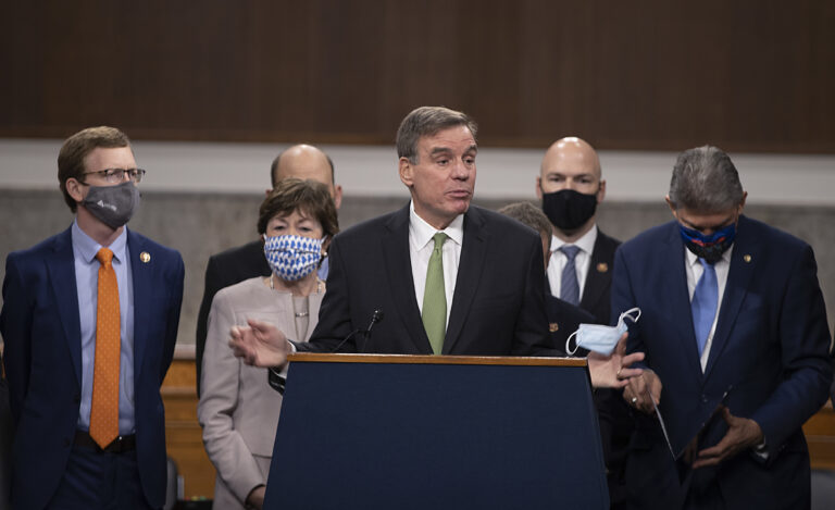 Sen. Mark Warner (D-VA) speaks alongside a bipartisan group of Democrat and Republican members of Congress as they announce a proposal for a $908 billion Covid-19 relief bill