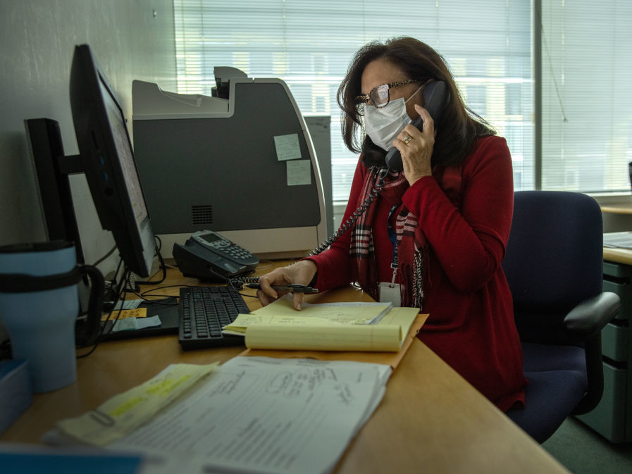 Contact tracer Toni Parlanti of Stamford, Conn., calls a person identified as having been potentially exposed to the coronavirus this week. States and territories report they have more than 70,000 people working on contact tracing as of December. Contact tracer Toni Parlanti of Stamford, Conn., calls a person identified as having been potentially exposed to the coronavirus this week. States and territories report they have more than 70,000 people working on contact tracing as of December. (John Moore/Getty Images)